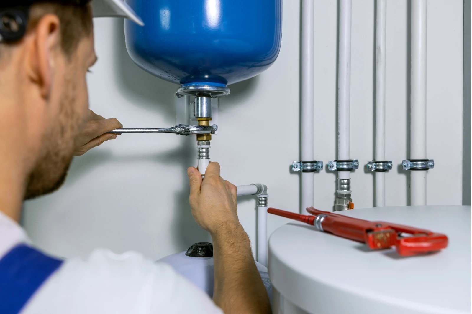 Emergency plumber fixing a leaking kitchen pipe in Dublin, urgent plumbing repair service.